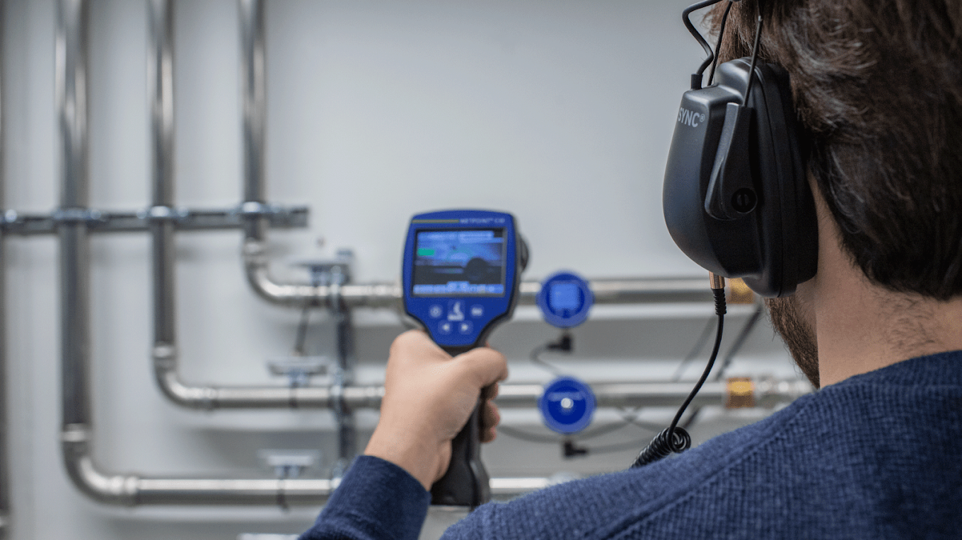 Acoustic Ultrasonic Leak Detection Technician with Noise-Canceling Headset