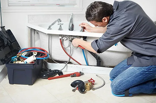 Licensed Plumber Performing Bathtub Rough-In Plumbing Repair with PEX and Copper Lines