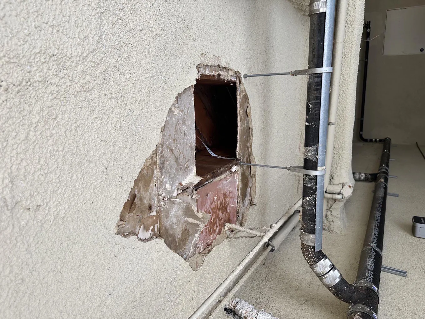 Targeted Wall Opening Exposing Concealed Plumbing Riser Stack for Precision Pipe Repair
