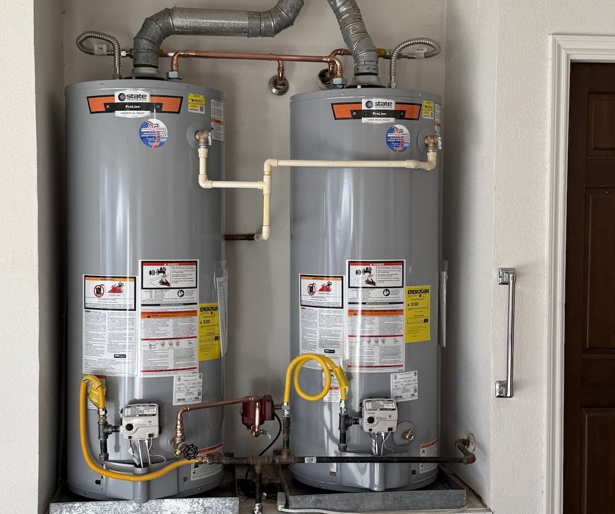 Dual State ProLine commercial-grade gas water heater installation with recirculating pump and flue venting