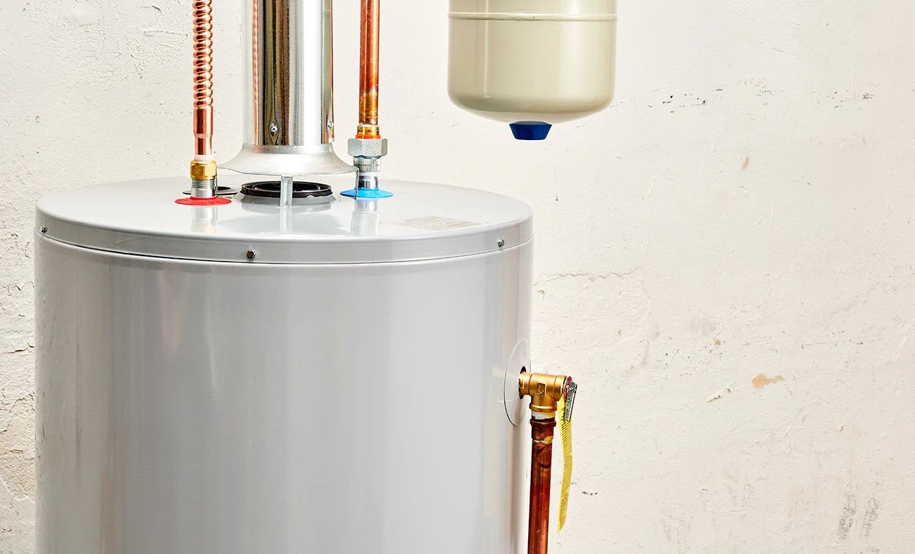 Residential water heater top with thermal expansion tank, brass temperature and pressure relief valve, and copper supply lines